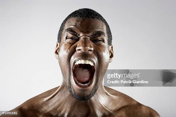 angry african man shouting - schreien stock-fotos und bilder