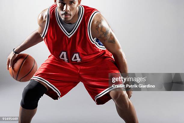 african basketball player bounding basketball - dribbling sport fotografías e imágenes de stock