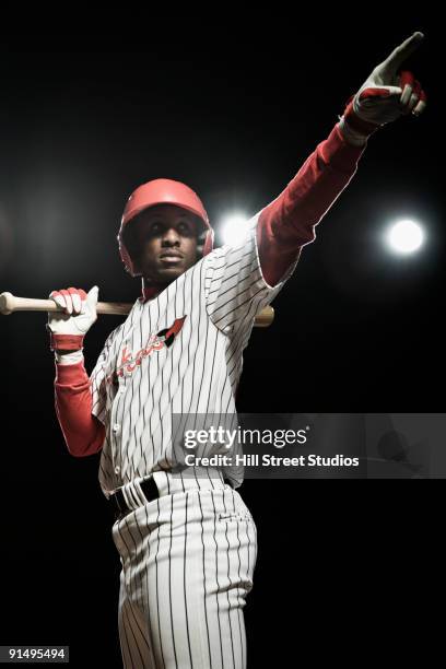 african baseball player holding bat and pointing - batting imagens e fotografias de stock