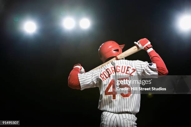 african baseball player holding bat - divisa da baseball foto e immagini stock