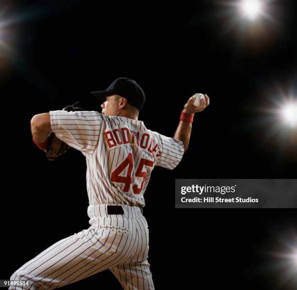mixed race baseball player pitching - pro baseball pitcher stock pictures, royalty-free photos & images