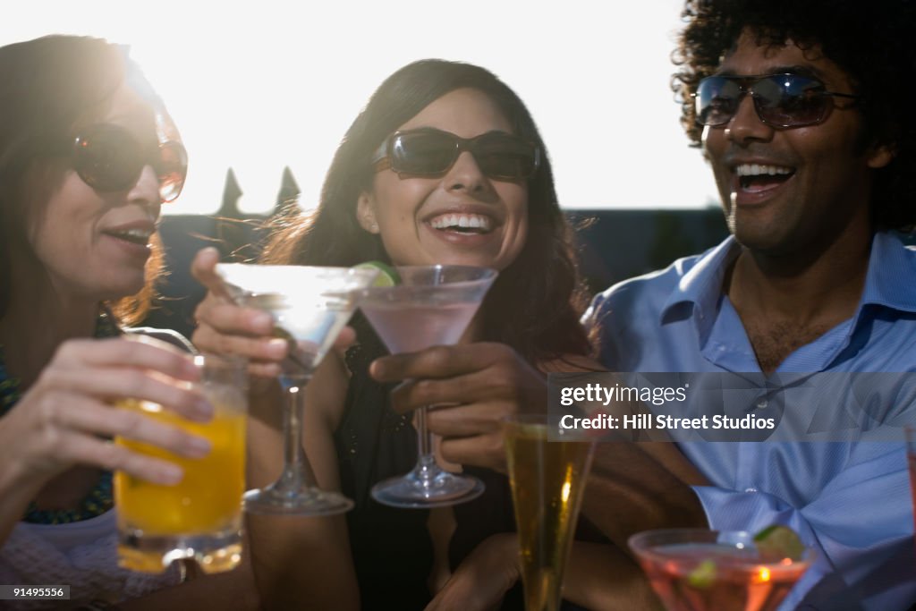 Multi-ethnic friends drinking cocktails