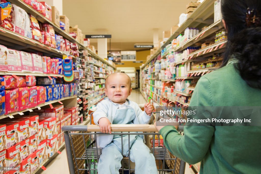 Mother shopping in grocery store with baby