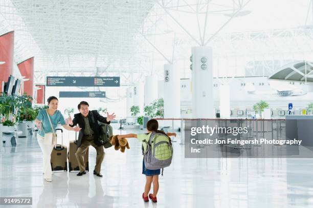 asian grandparents greeting granddaughter in airport - families meeting inside stock pictures, royalty-free photos & images