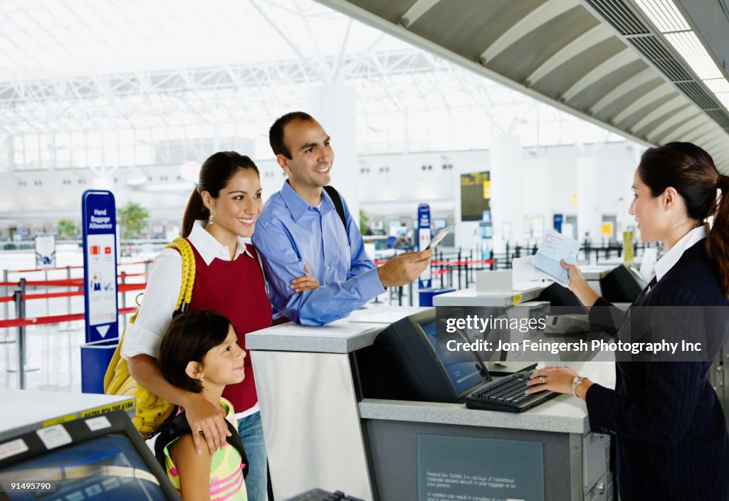 Hispanic family checking in at airport