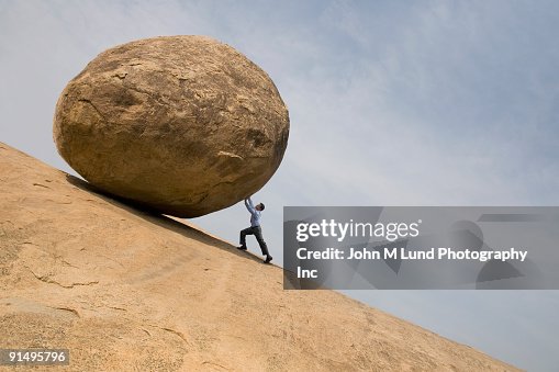 Guy Running Down Red Rocks Backwards Man Pushing Rock Up Hill