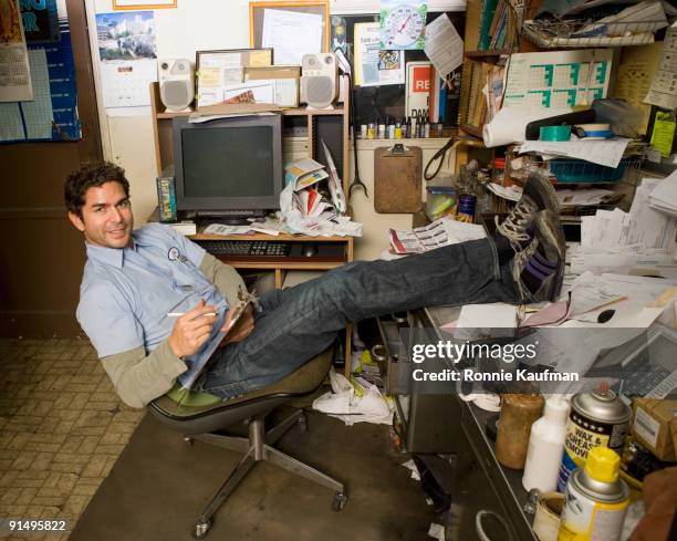 hispanic mechanic in garage office - disheveled man imagens e fotografias de stock