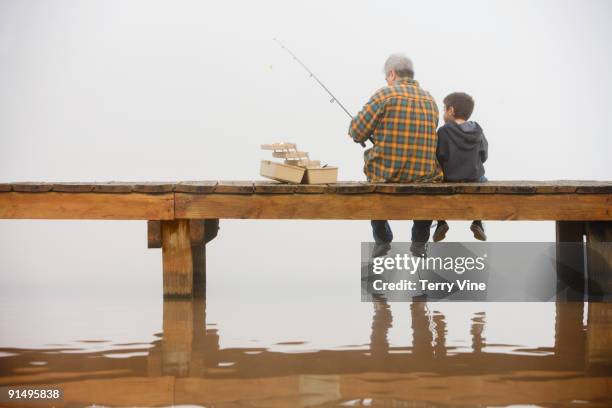 grandfather and grandson fishing off dock - role model - fotografias e filmes do acervo