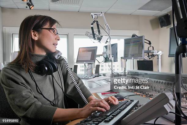 asian dj working at radio station - arts culture and entertainment stock pictures, royalty-free photos & images