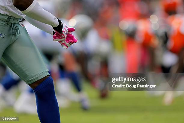 Wide receiver Roy Williams goes to the line of scrimmage wearing pink gloves as part of a program to raise awareness for breast cancer as the Dallas...