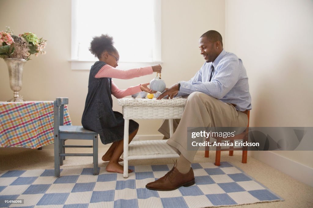 African father and daughter playing tea