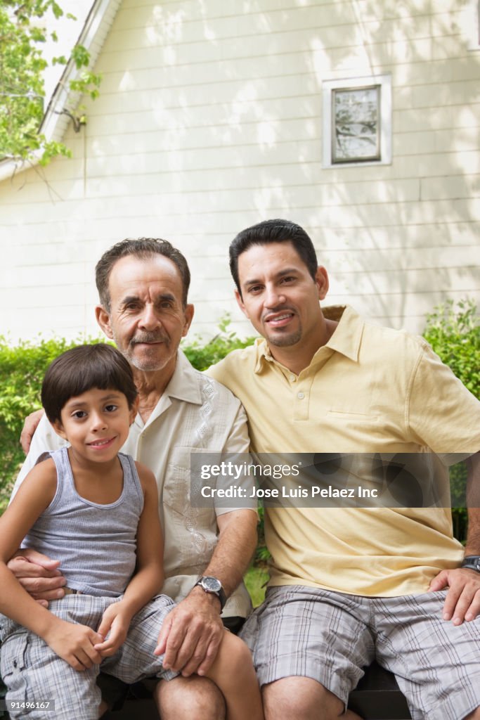 Multi-generational Hispanic family sitting outdoors