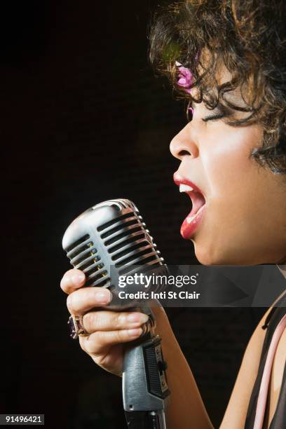 close up of african female singer - microphone mouth stock-fotos und bilder