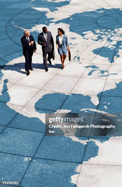 businesspeople walking on map of globe - 90s business people stock pictures, royalty-free photos & images