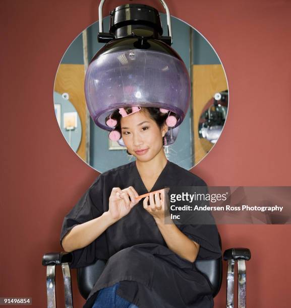 asian woman under hair dryer in salon - cabeleireiro imagens e fotografias de stock