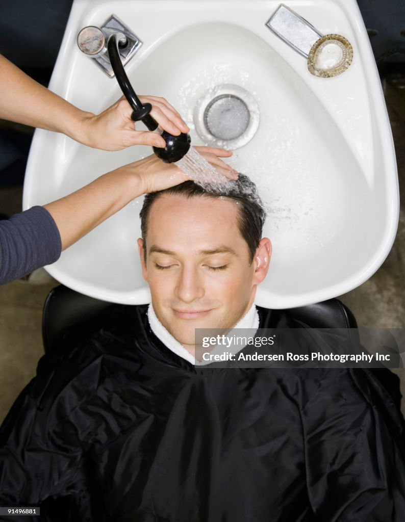 Man having hair washed at salon