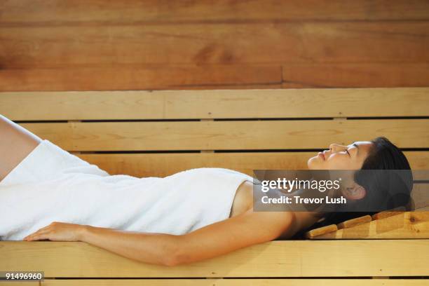 asian woman relaxing in sauna - beautiful woman sleeping stock pictures, royalty-free photos & images