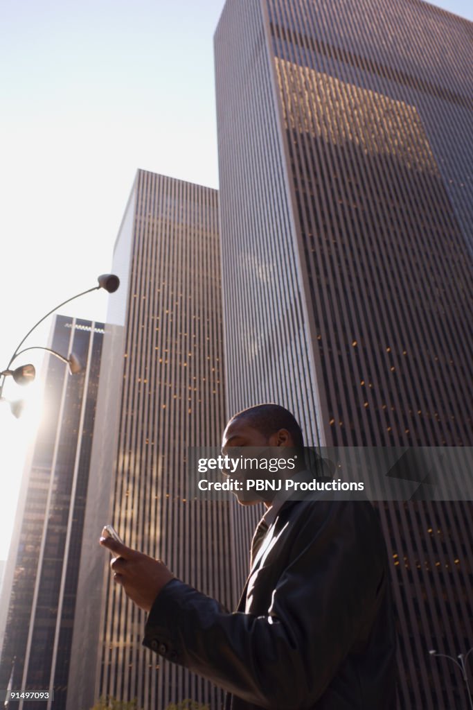 African American businessman looking at cell phone
