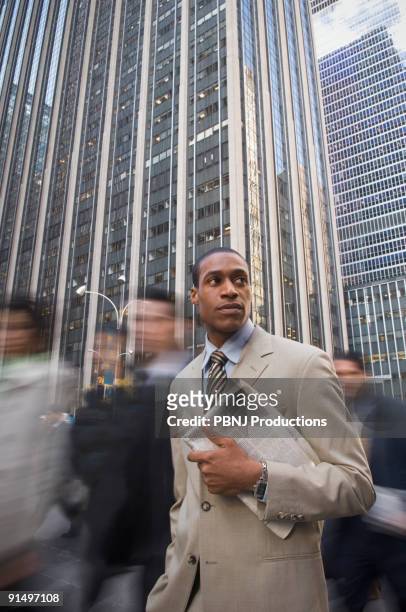 african american businessman holding newspaper - asking time stock pictures, royalty-free photos & images