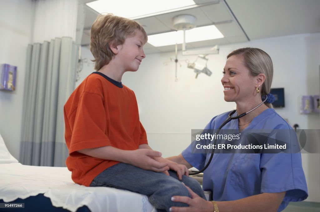 Female medical professional examining boy