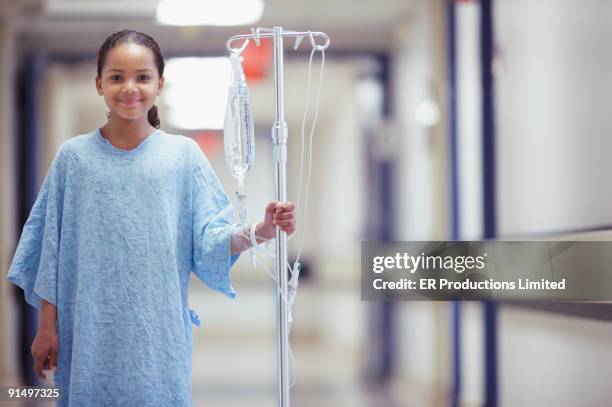 mixed race girl in hospital gown - patient medical gown stock pictures, royalty-free photos & images