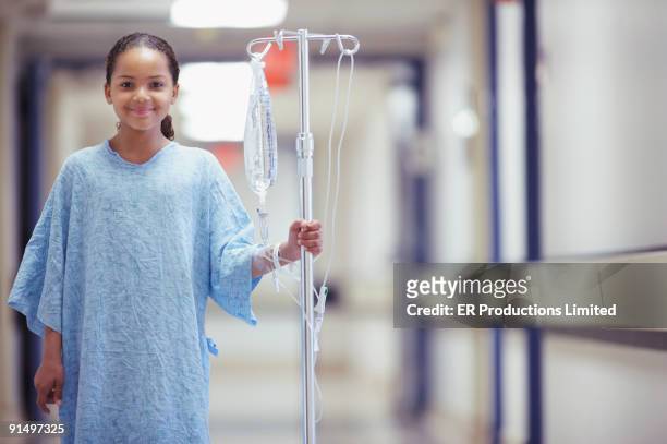 mixed race girl in hospital gown - hospital gown imagens e fotografias de stock