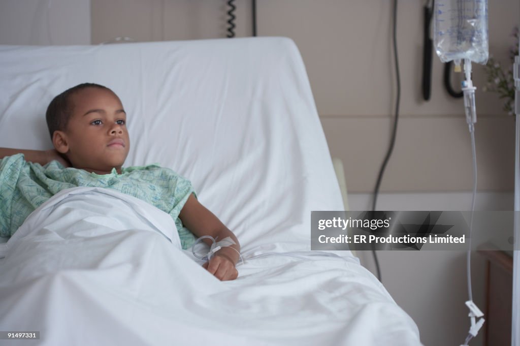 Mixed Race boy in hospital bed