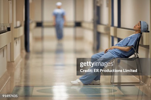 Asian female medical professional sitting in chair Asian female medical professional sitting in chair