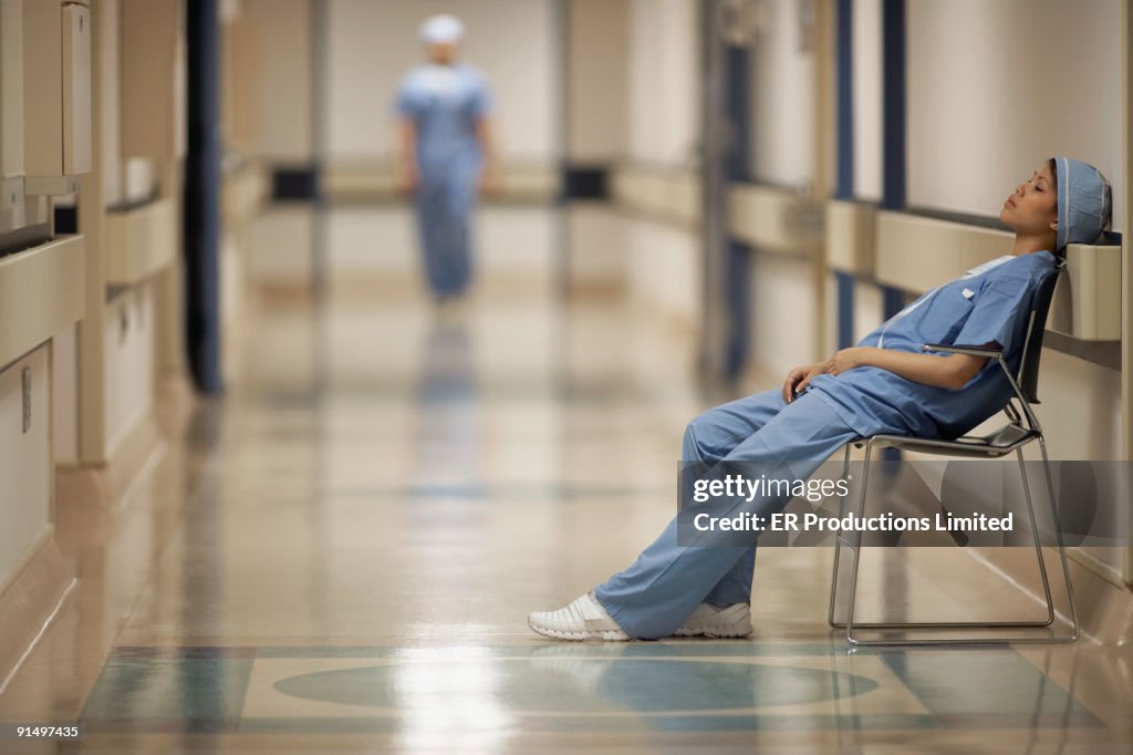 Asian female medical professional sitting in chair