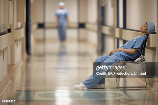 asian female medical professional sitting in chair - nurse with surgical mask stock pictures, royalty-free photos & images