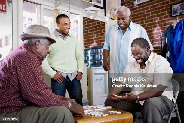 african men playing dominos - dominoes stock pictures, royalty-free photos & images