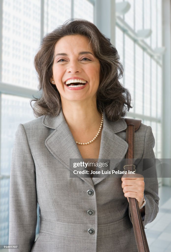Hispanic businesswoman laughing