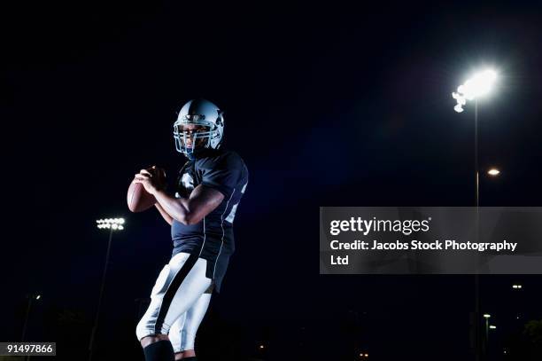 african football player throwing football - american football professional player not soccer stock pictures, royalty-free photos & images