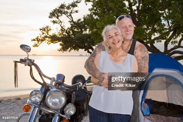 mother and tattooed son camping at the beach - old woman tattoos stock pictures, royalty-free photos & images