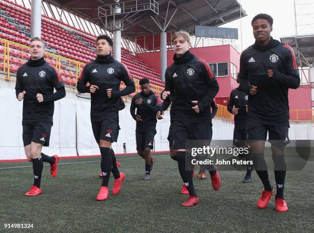 Ethan Hamilton, Nishan Burkart and Tyrell Warren of Manchester United U19s in action during a training session at Vozdovac Stadium on February 6,...