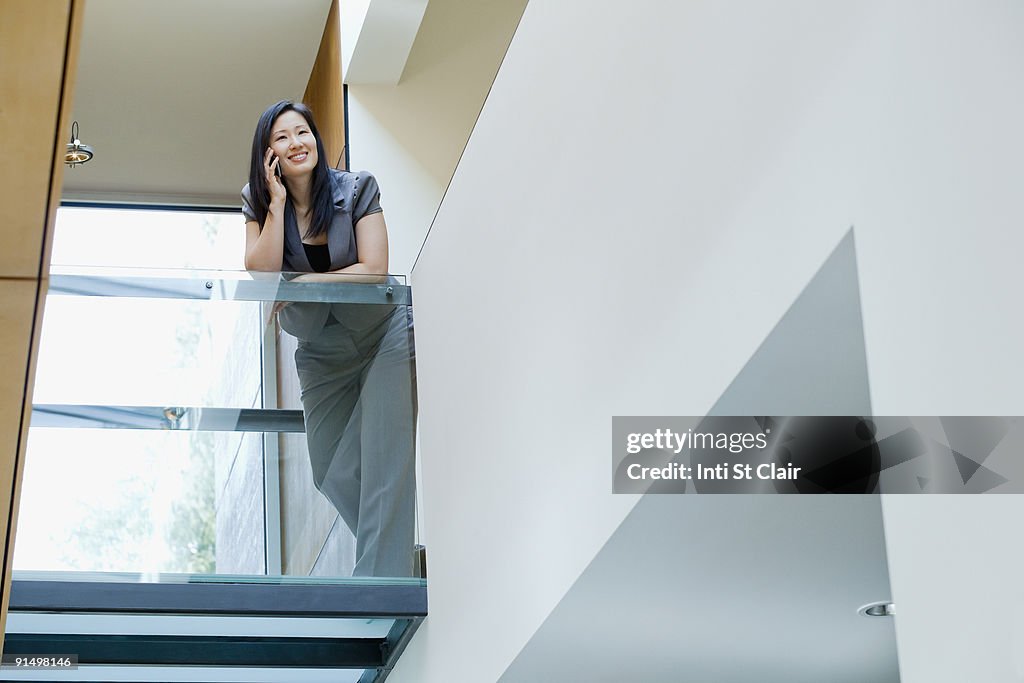 Asian businesswoman talking on cell phone in office