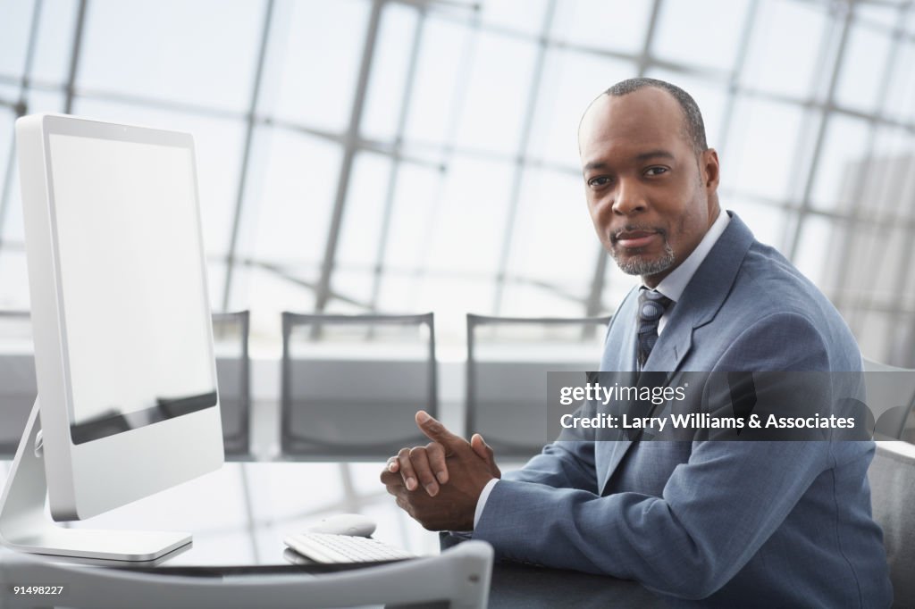 African businessman sitting at conference table