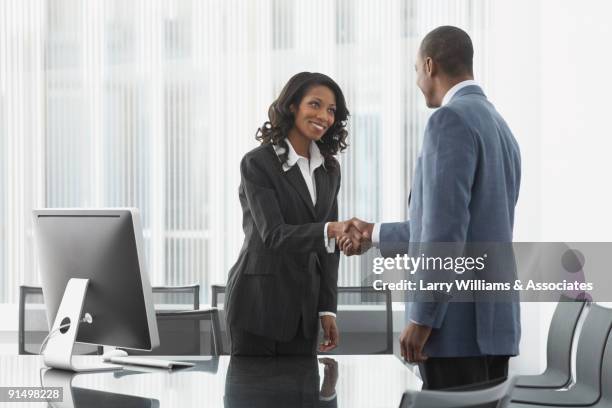 african business people shaking hands - black men shaking stock pictures, royalty-free photos & images