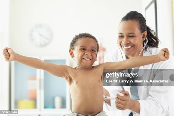 african female doctor examining african boy - doctoring stock pictures, royalty-free photos & images