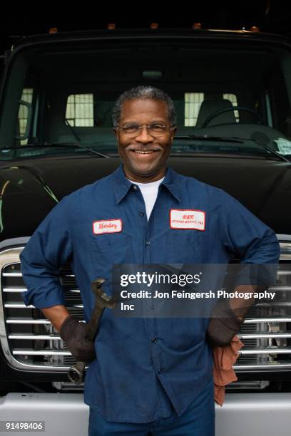 african mechanic standing in front of truck - mechanic uniform stock pictures, royalty-free photos & images