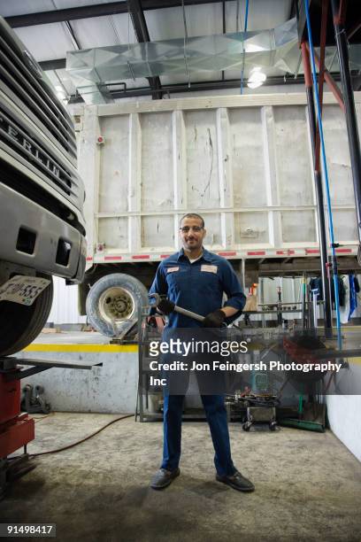 middle eastern mechanic in repair shop - mechanic uniform stock pictures, royalty-free photos & images