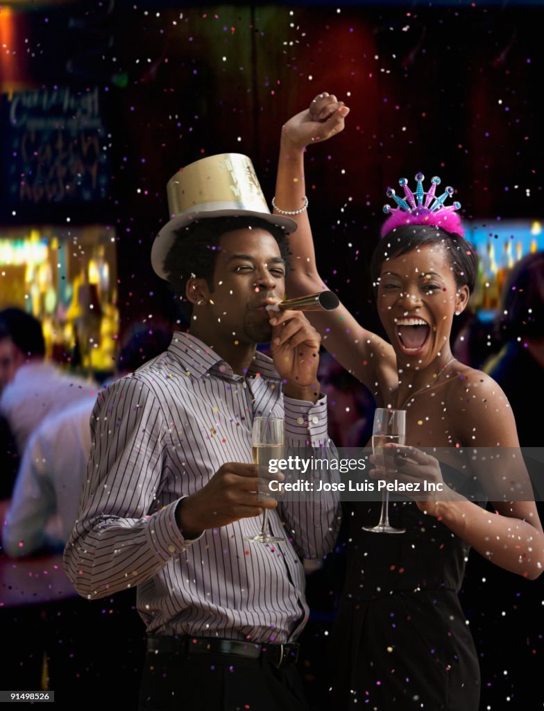 African couple celebrating New Year's Eve in nightclub
