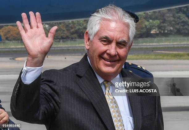 Secretary of State Rex Tillerson, waves to journalists at the Catam Military Airport in Bogota on February 6, 2018. / AFP PHOTO / Luis ACOSTA