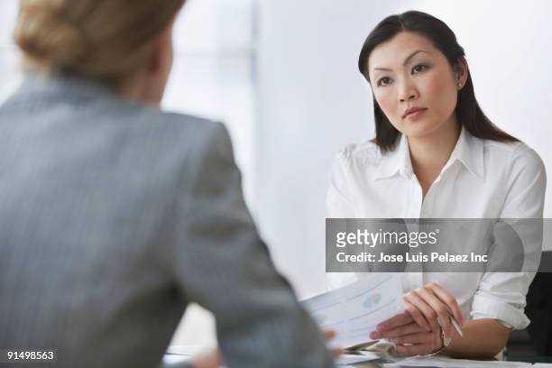 businesswomen in meeting - serious interview stock pictures, royalty-free photos & images