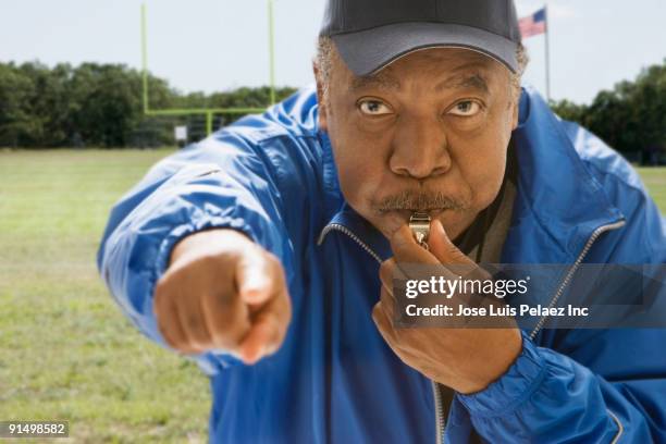 african football referee blowing whistle - coach whistle stock pictures, royalty-free photos & images