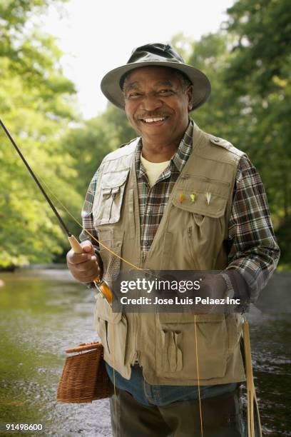 african man in fishing vest - fiskeväst bildbanksfoton och bilder