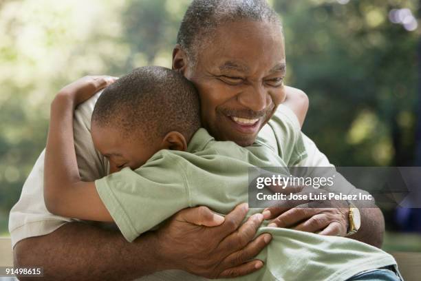 african grandfather and grandson hugging - grandfather and grandson stock pictures, royalty-free photos & images