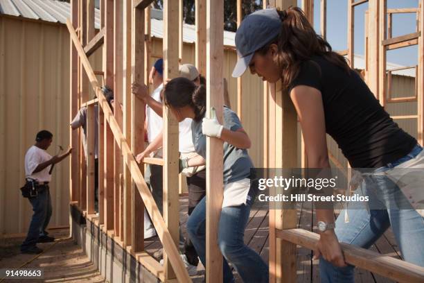 men and women working at construction site - community imagens e fotografias de stock