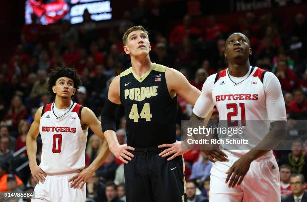 Isaac Haas of the Purdue Boilermakers between Geo Baker and Mamadou Doucoure of the Rutgers Scarlet Knights during a game at Rutgers Athletic Center...