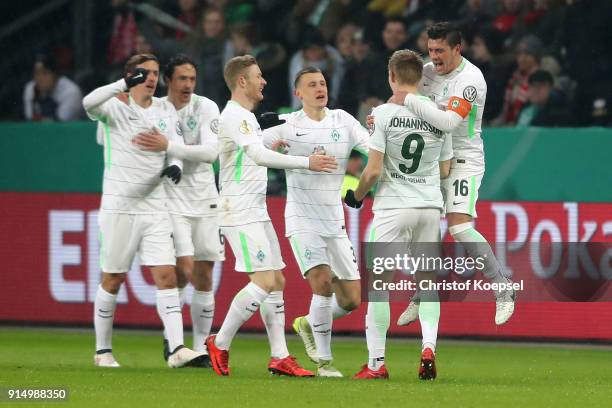 Aron Johansson of Bremen celebrates the second goal with his team mates during the DFB Cup quarter final match between Bayer Leverkusen and Werder...